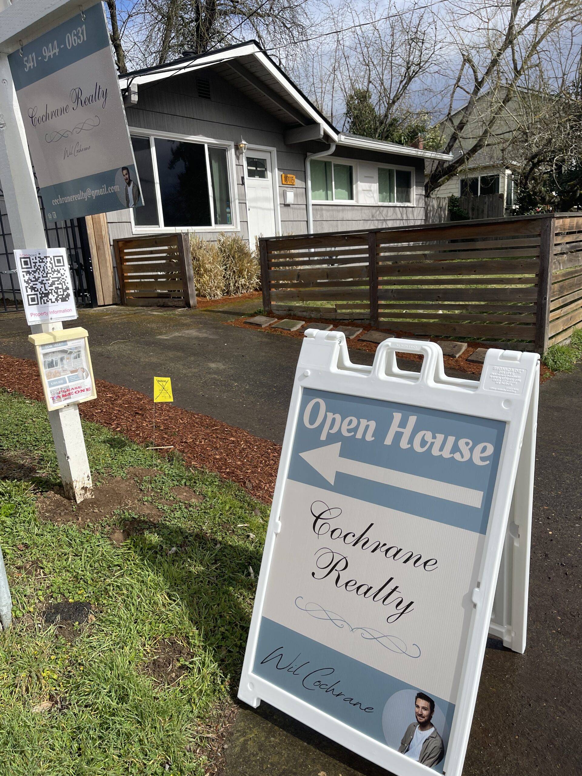 Cochrane Realty open-house sign outside a home